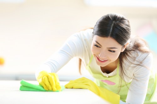 Cleaner in Shoreditch preparing an office workspace for the day